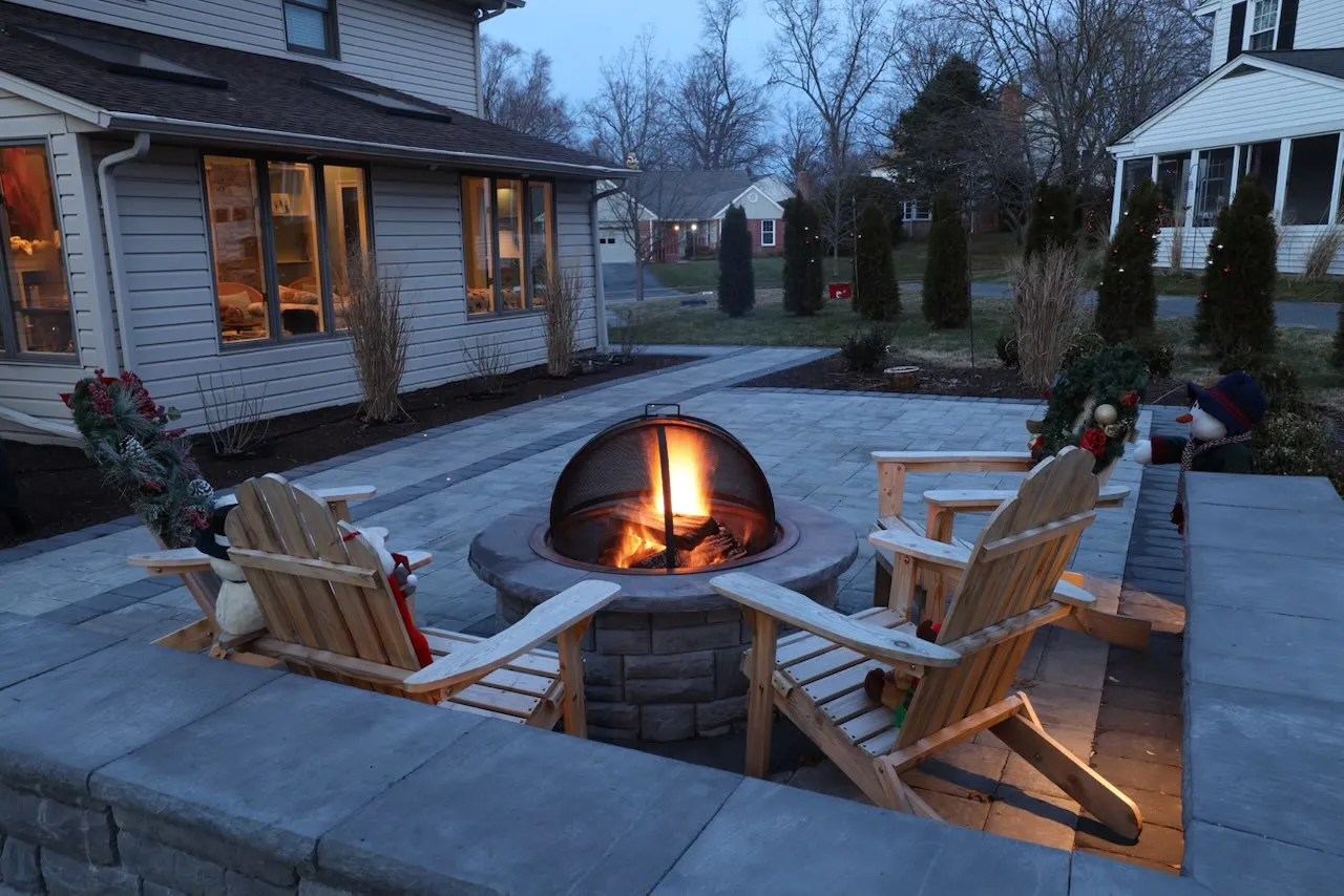 A finished paver patio with a fire pit and seating area in Delaware.