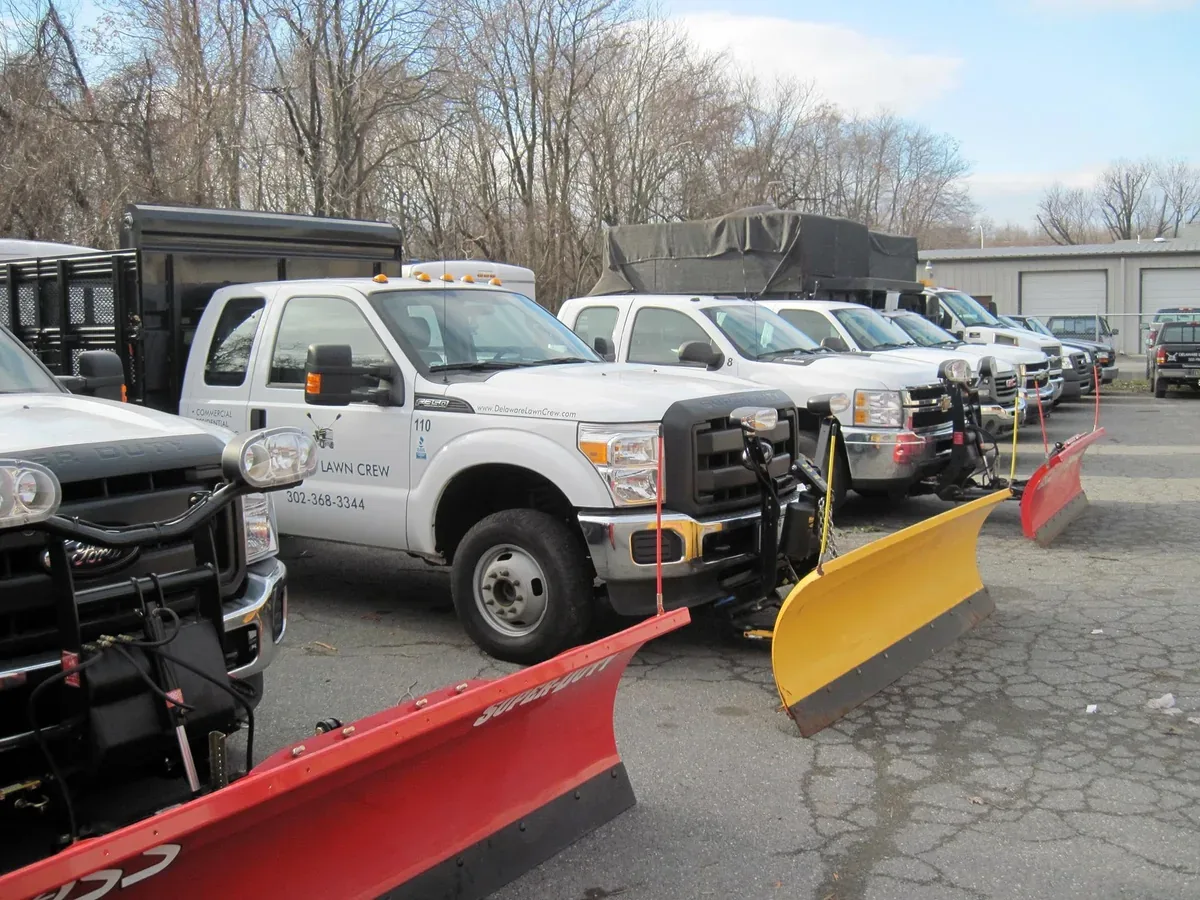 Delaware Lawn Crew's own fleet of plow trucks lined up and ready for a storm.